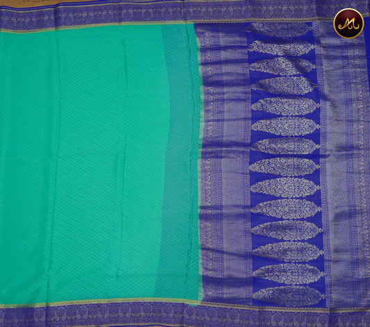 Mysore Crepe Silk saree with KSIC finish in Teal and  Royal Blue combination with embosss work allover the body and Rich  Pallu