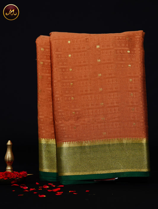 Mysore Crepe Silk saree with KSIC finish in Rare Gold  and Bottle Green combination with Silk Emboss allover the body and Grand Pallu