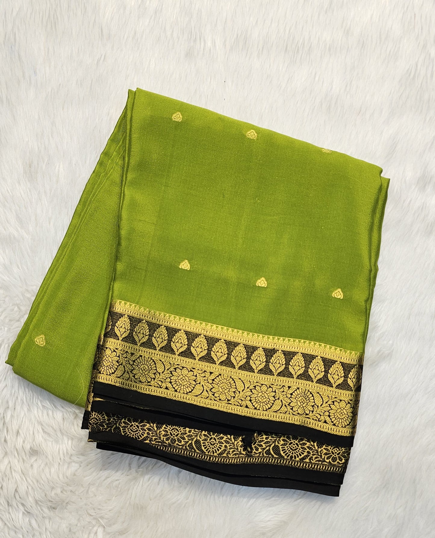 Mysore crepe silk saree with KSIC Finish in mehendi green with black in zari butta pattern