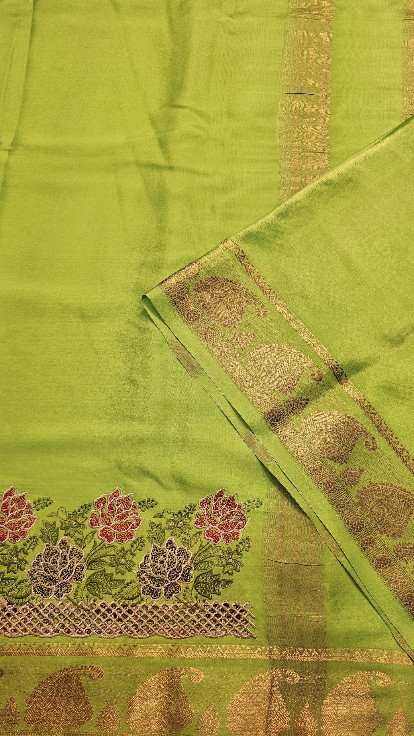 Mysore crepe silk saree with KSIC Finish in parrot green self in one side cutwork pattern
