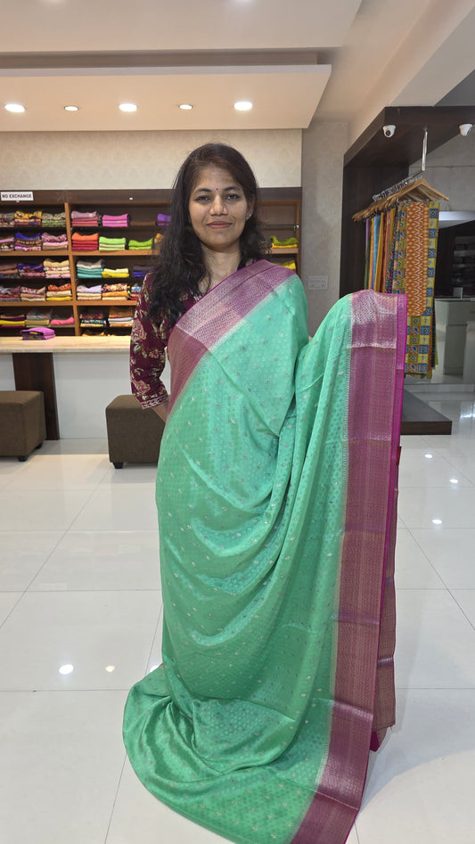 Mysore crepe silk saree with KSIC Finish in distemper green with rani pink in allover zari buttas pattern