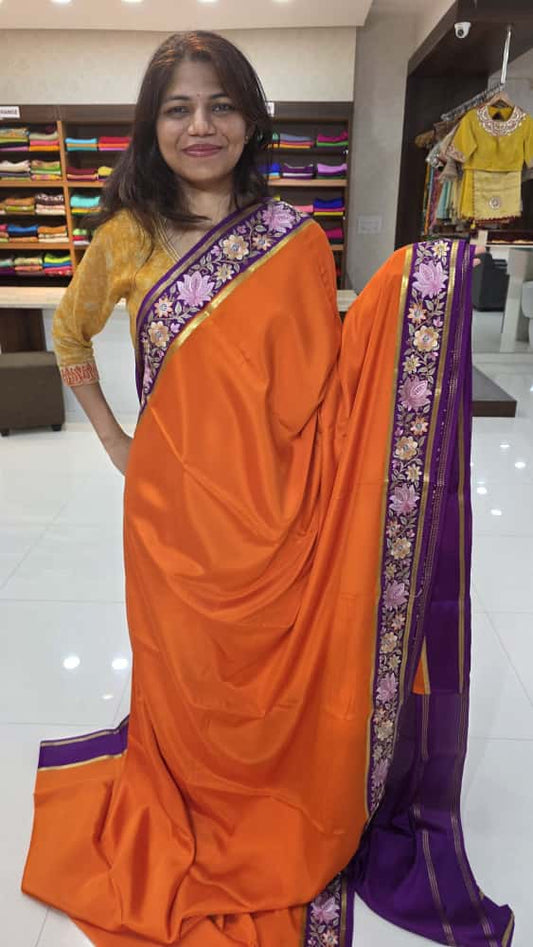 Mysore crepe silk sarees in KSIC Finish in orange with purple 2 side embroidery pattern