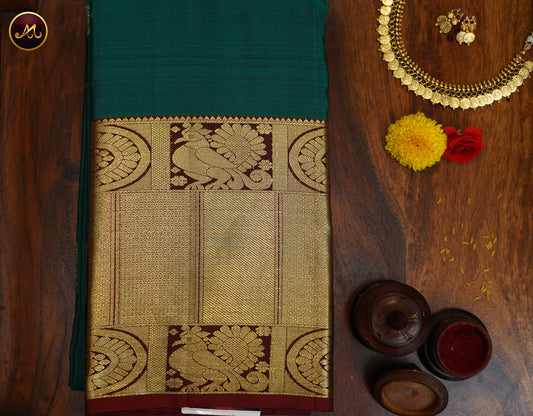 Kanchivaram Handloom Pure Silk in Butta Pattern in Peacock green  And Maroon combination with Gold Zari  Border and Rich Pallu