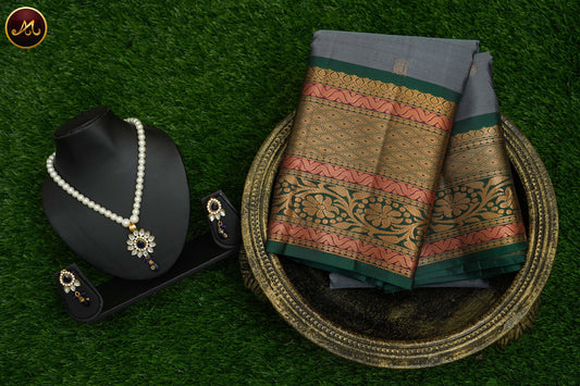 Pure Kanchi Silk Saree with body in Grey colour and Buttas allover and Bottle Green Long Border