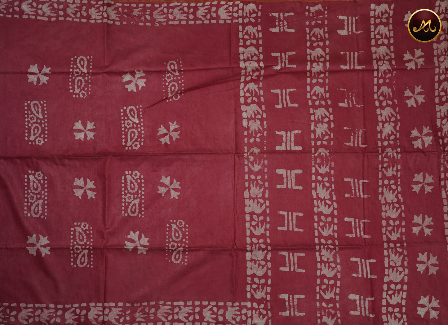 Cotton batik print saree in onion pink and pencil zari border.