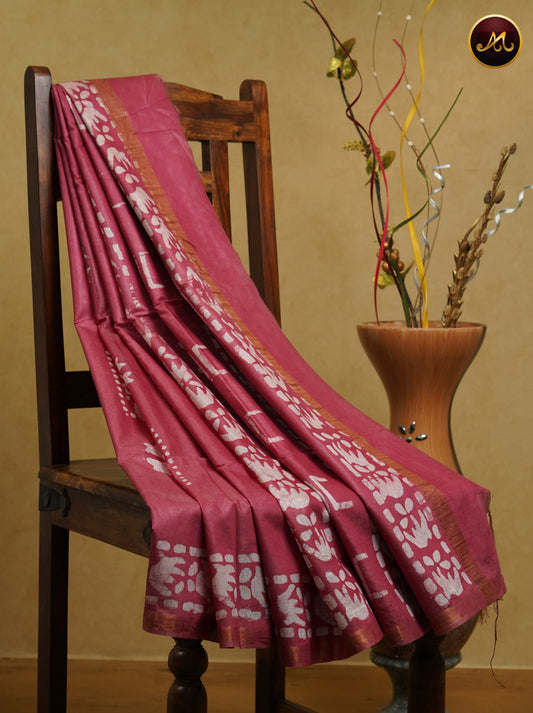 Cotton batik print saree in onion pink and pencil zari border.