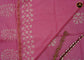 Cotton batik print saree in baby pink and pencil zari border.