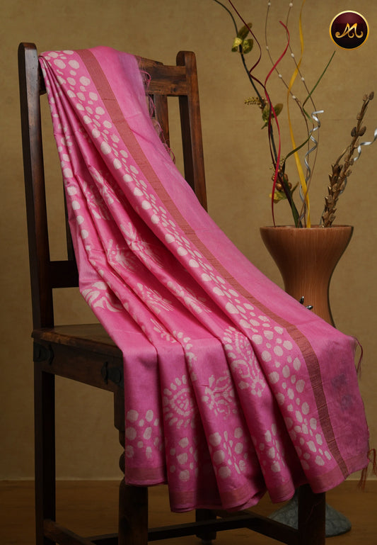 Cotton batik print saree in baby pink and pencil zari border.