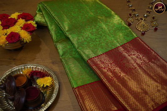Kanchivaram Pure Silk  Tissue Saree in Parrot Green and Red colour combination with brocade work, long and short border in Gold zari and rich pallu