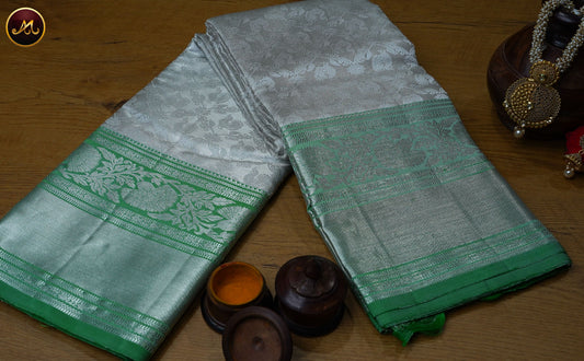 Kanchivaram Pure Silk Saree in silver and leaf green combination with emboss work, silver zari border and rich pallu