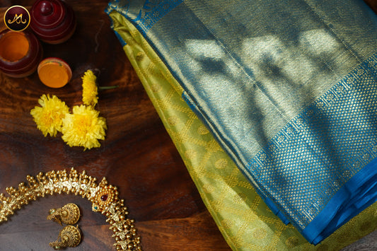 Kanchivaram Pure Silk Tissue Saree in parrot green and ananda blue combination with emboss work, long and short border in gold zari and rich pallu