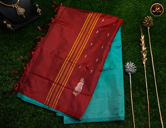 Banana silk saree in rama green and brick red combination with thread work motifs