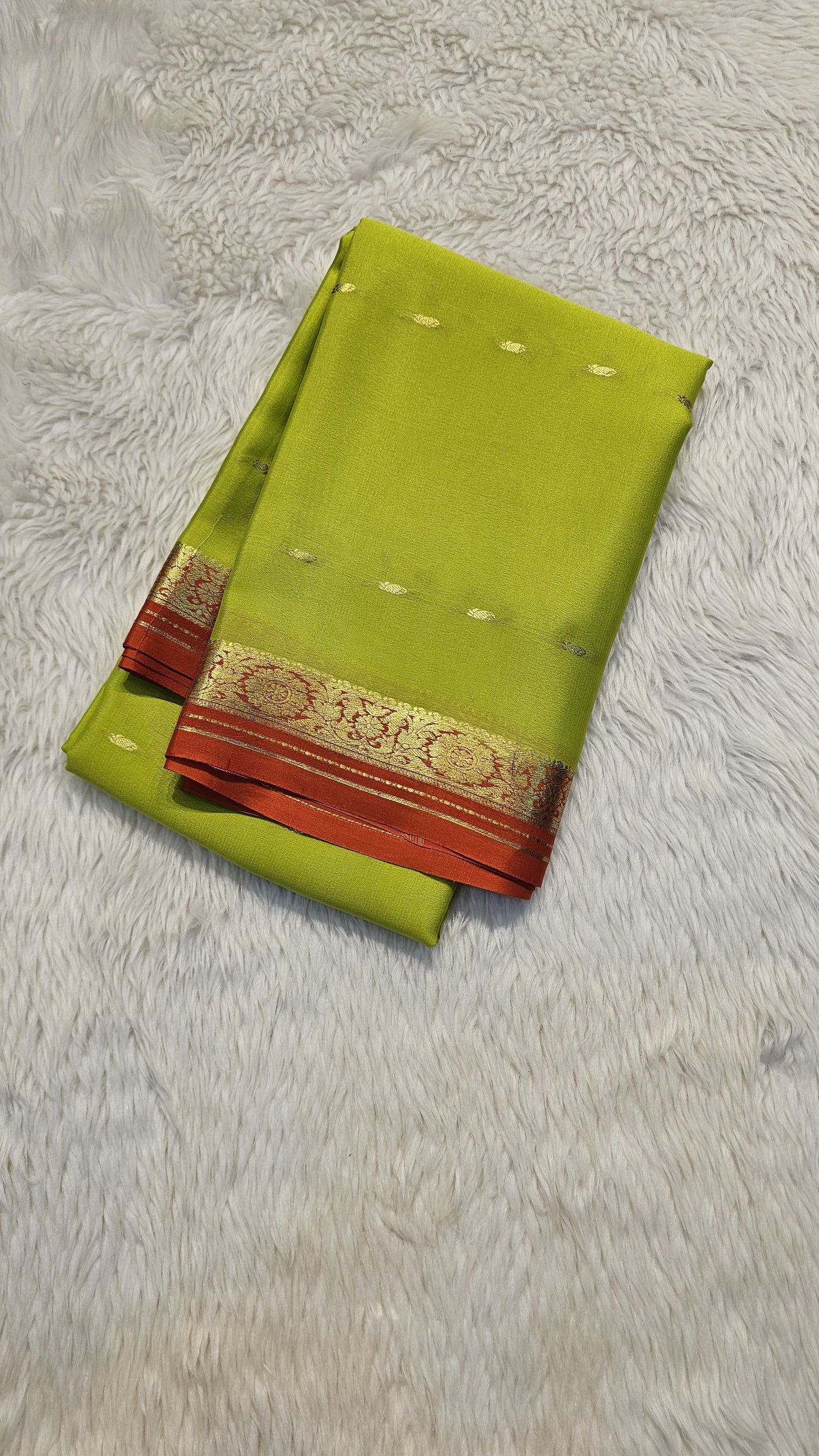 Mysore crepe silk saree with KSIC Finish in lemon green with orange in small zari motifs pattern