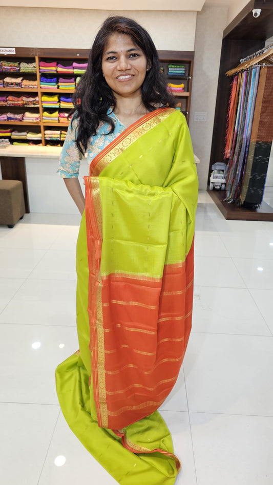 Mysore crepe silk saree with KSIC Finish in lemon green with orange in small zari motifs pattern