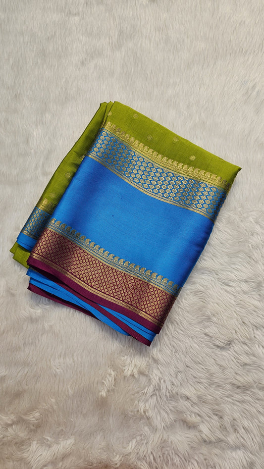 Mysore crepe silk saree with KSIC Finish in mehendi green with ananda blue in allover buttas pattern