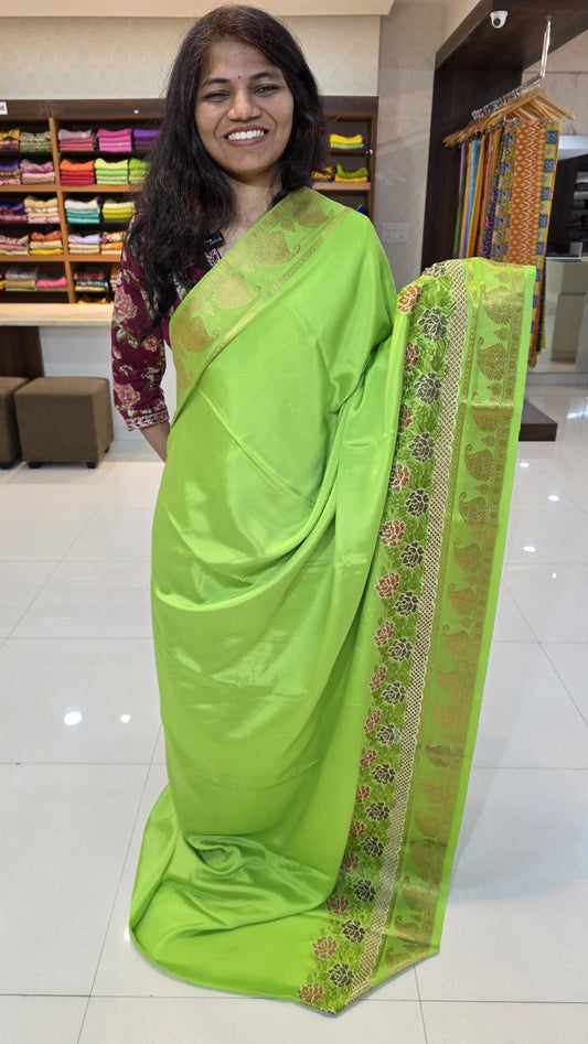 Mysore crepe silk saree with KSIC Finish in parrot green self in one side cutwork pattern