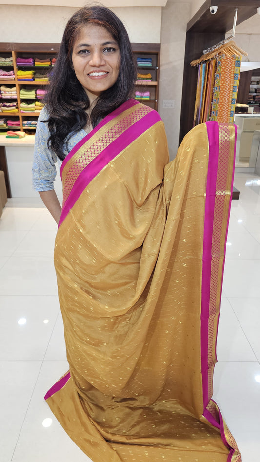 Mysore crepe silk saree with KSIC Finish in gold with rani pink in allover buttas pattern