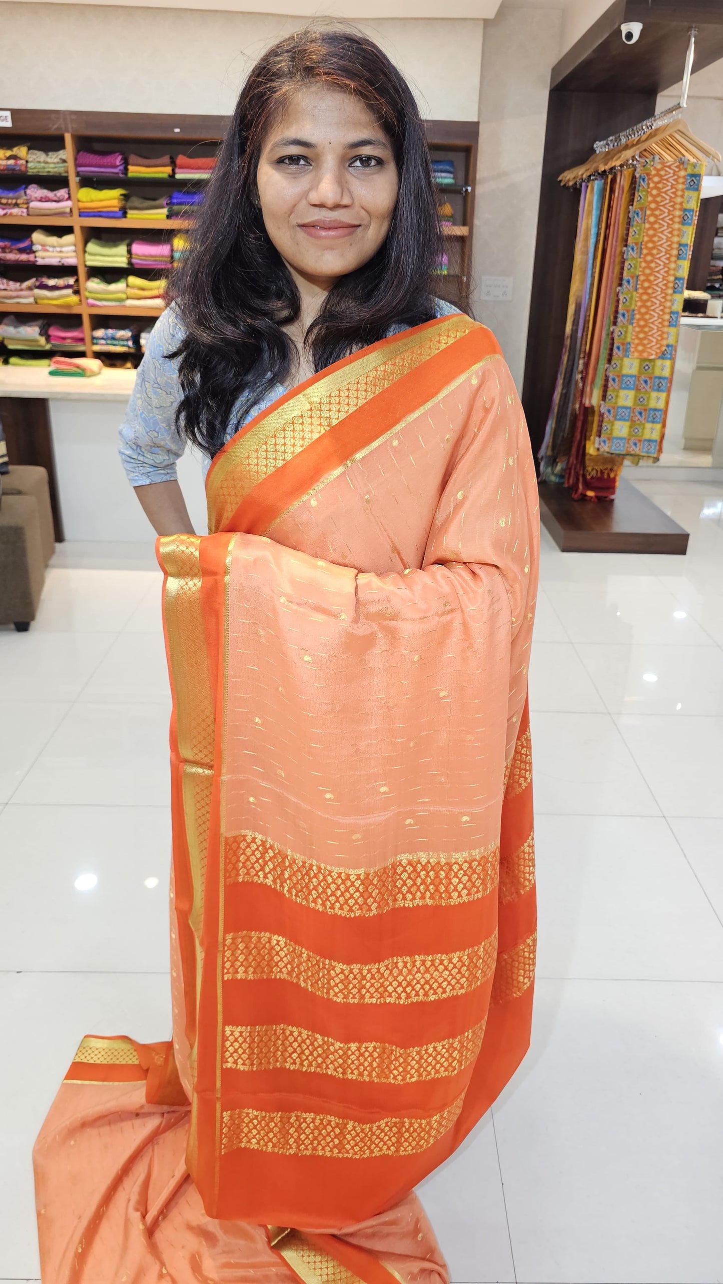 Mysore crepe silk saree with KSIC Finish in peach with orange in allover buttas pattern