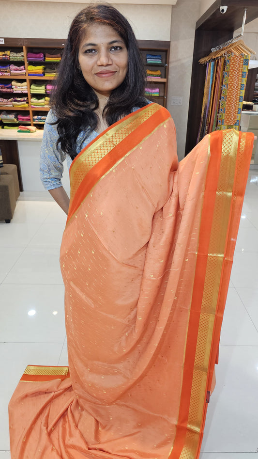Mysore crepe silk saree with KSIC Finish in peach with orange in allover buttas pattern