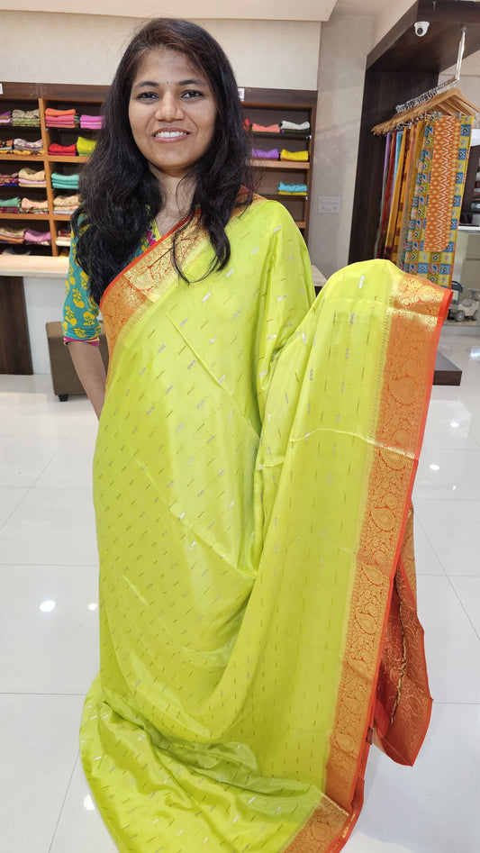 Mysore crepe silk saree with KSIC Finish in lemon green with orange in mango border pattern