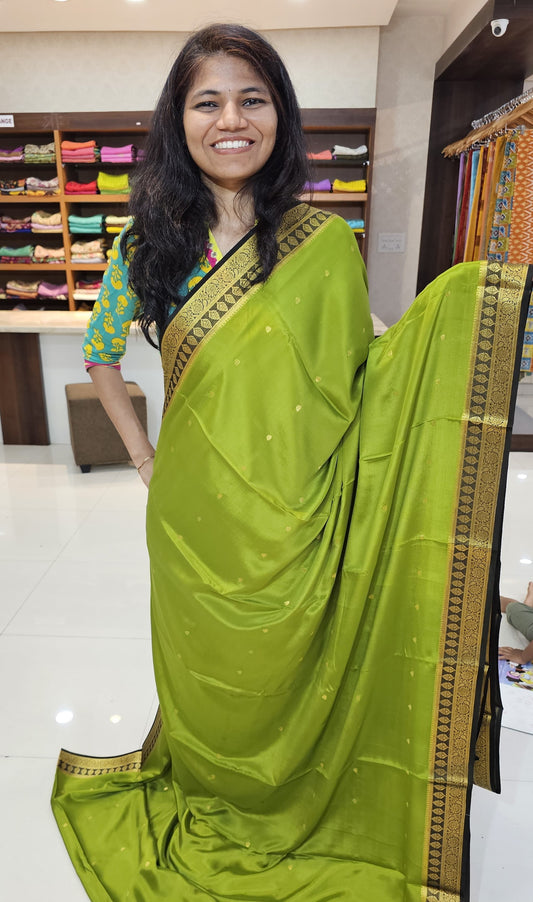 Mysore crepe silk saree with KSIC Finish in mehendi green with black in zari butta pattern
