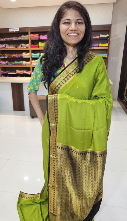 Mysore crepe silk saree with KSIC Finish in mehendi green with black in zari butta pattern