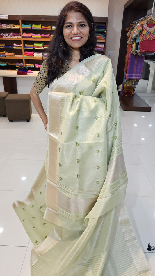 Semi organza fancy saree in pista green self in silver zari border with allover butts