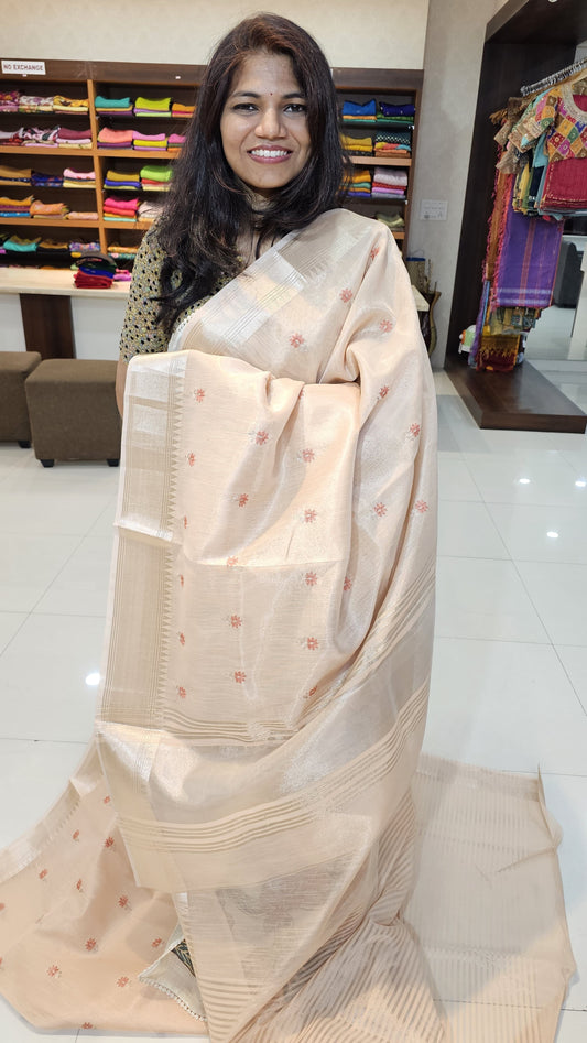 Semi organza fancy saree in peach self in silver zari border with allover butts