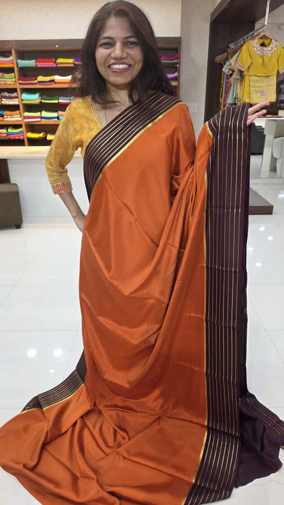 Mysore crepe silk sarees in KSIC Finish in rust orange with brown lines border
