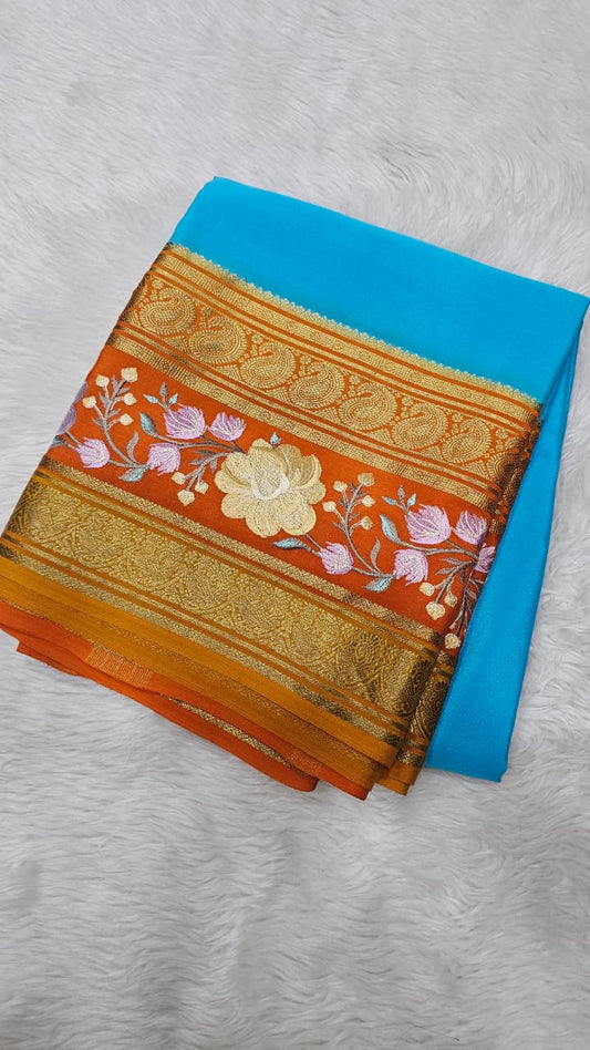 Mysore crepe silk saree in KSIC Finish in ananda blue with orange  embroidery pattern