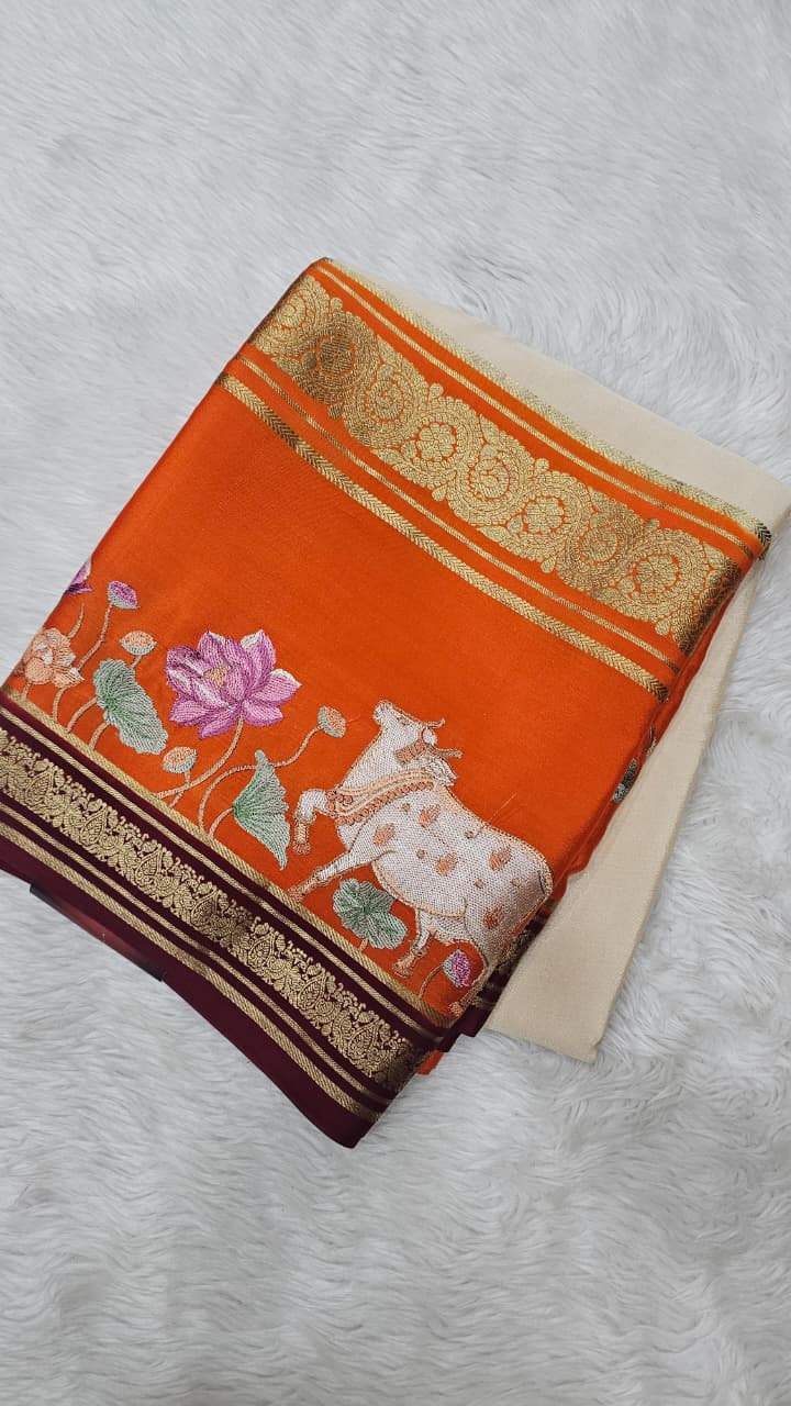 Mysore crepe silk saree in KSIC Finish in cream with orange pichwai embroidery pattern